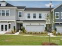 New two-story home featuring a two-car garage, manicured lawn, and classic gray siding at 507 Webster Ln, Cramerton, NC 28032