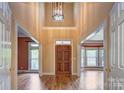 Grand foyer with high ceilings, hardwood floors, and a striking light fixture creates an elegant entrance at 8044 Hawk Crest Ct, Charlotte, NC 28270