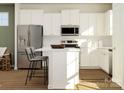 Stylish kitchen with white cabinetry, stainless appliances, and a center island perfect for entertaining at 8426 Norman Forest Rd, Lancaster, SC 29720