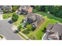 Aerial view of the property showcasing its well-maintained lawn, mature trees, and proximity to neighboring homes at 10106 Silverling Dr, Waxhaw, NC 28173