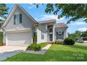Charming exterior view featuring a well-maintained lawn and inviting front entrance at 1013 Nez Perce Ln, Monroe, NC 28110