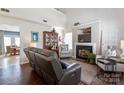 Cozy living room featuring a fireplace, comfortable seating, and wood flooring at 1013 Nez Perce Ln, Monroe, NC 28110