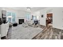 Bright living room with a fireplace, hardwood floors, and lots of natural light at 10135 Blakeney Preserve Dr, Charlotte, NC 28277