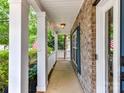 Charming front porch with white columns offers a welcoming entrance to the home at 1016 Yellow Daisy Dr, Matthews, NC 28104