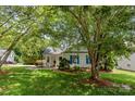 Beautiful home featuring a well-kept lawn, inviting front porch with seating, and shade trees at 10621 Glenmac Rd, Charlotte, NC 28215