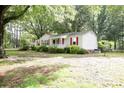 Lovely single-story home with a covered porch, nestled in a lush green yard with mature trees at 1270 N Enochville Ave, China Grove, NC 28023