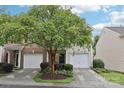 Charming two-story home with a well maintained lawn and vibrant landscaping at 14018 Drake Watch Ln, Charlotte, NC 28262