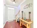 Bright foyer with hardwood floors, staircase, and elegant decorative accents at 14018 Drake Watch Ln, Charlotte, NC 28262