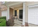Welcoming front porch with seating, address numbers, and manicured landscaping at 14018 Drake Watch Ln, Charlotte, NC 28262