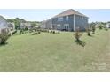 Expansive backyard with mature landscaping, a fenced perimeter and a patio area, ideal for relaxation at 151 Outrigger Ln, Troutman, NC 28166