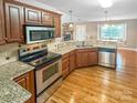 Well-equipped kitchen featuring stainless steel appliances, granite countertops, and hardwood floors at 1625 Damascus Cir, Conover, NC 28613