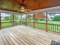 Relaxing screened porch with wood flooring and ceiling fan, offering views of the well-maintained backyard at 1625 Damascus Cir, Conover, NC 28613