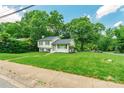 Well-maintained two-story home with lush green lawn and mature trees in a serene neighborhood at 1645 Brookdale Ave, Charlotte, NC 28210