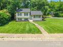 Inviting two-story home with a lush front yard and welcoming walkway in a peaceful neighborhood at 1645 Brookdale Ave, Charlotte, NC 28210