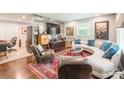 Cozy living room featuring a curved sofa, stylish decor, and a unique accent wall at 1645 Brookdale Ave, Charlotte, NC 28210