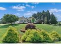 Beautifully landscaped front yard with lush greenery and mature trees surrounding a well-maintained home at 166 Rumple Hill Dr, Statesville, NC 28677