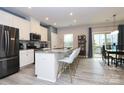 Modern kitchen features a large island with bar seating and stainless steel appliances at 1723 Town Oak Ln, Charlotte, NC 28205
