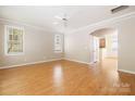 Bright, airy living room with hardwood floors, a ceiling fan, and large windows at 181 Singleton Rd, Mooresville, NC 28117