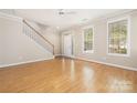 Inviting living room features hardwood floors, a staircase, and two bright windows at 181 Singleton Rd, Mooresville, NC 28117