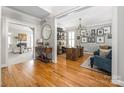 Stylish home office featuring hardwood floors, a large desk, and a comfortable seating area at 188 Lilac Mist Loop, Mooresville, NC 28115