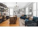 Bright home office with built-in shelving, a modern desk, and comfortable seating at 188 Lilac Mist Loop, Mooresville, NC 28115