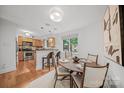 Inviting dining area adjacent to the kitchen with modern lighting and wood floors at 201 N Dotger Ave # C8, Charlotte, NC 28207