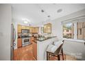 Modern kitchen with stainless steel appliances, bar seating, and ample natural light at 201 N Dotger Ave # C8, Charlotte, NC 28207