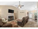 Cozy living room with a fireplace, ceiling fan, hardwood floors, and comfortable seating at 209 Mcfadden St, Rock Hill, SC 29730