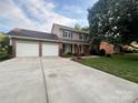 Traditional two-story home features a large driveway, attached garage, and manicured lawn at 228 31St Avenue Ne Ct, Hickory, NC 28601
