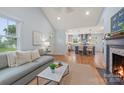 Open-concept living room boasts natural light, wood floors, and views of the kitchen with bar seating at 2421 Morton St, Charlotte, NC 28208