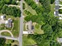 Aerial view of a secluded home surrounded by lush greenery and a nearby roadway at 2617 Shady Lane Ave, Concord, NC 28027