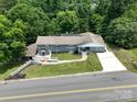 Eye-level, this home boasts a well-manicured lawn, a concrete driveway, and a charming facade at 2617 Shady Lane Ave, Concord, NC 28027