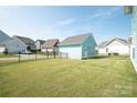 Fenced backyard featuring a well-maintained lawn and blue storage garage, providing privacy and storage at 282 Auburn View Rd, Rock Hill, SC 29730