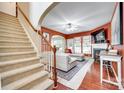 Spacious living room featuring a cozy fireplace, a plush sectional sofa, and a staircase, perfect for Gathering gatherings at 288 Sand Paver Way # 50, Fort Mill, SC 29708