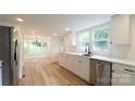 Bright kitchen featuring white cabinets, modern appliances, and wood flooring, offering a clean and stylish design at 301 Carolina Blvd, Salisbury, NC 28146