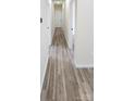 Inviting hallway with durable wood-look flooring and neutral paint, creating a warm transition space at 306 E Ratchford Ave, Gastonia, NC 28054
