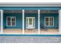 Inviting front porch featuring classic white columns, seating, and a beautifully designed front door at 3103 at 3103 Richview Dr, Crouse, NC 28033