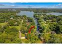 Aerial view featuring lake access with an arrow pointing to the property amid lush greenery at 315 Wood Duck Loop, Mooresville, NC 28117