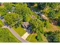 An aerial view shows the property with lake access, mature trees, and a well-maintained lawn at 315 Wood Duck Loop, Mooresville, NC 28117