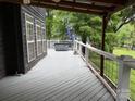 Relaxing outdoor deck featuring views of mature landscaping, a hot tub, and space for entertainment at 315 Wood Duck Loop, Mooresville, NC 28117