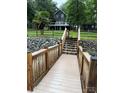 Wooden steps lead to waterfront dock access from the home, with views of the backyard and lake at 315 Wood Duck Loop, Mooresville, NC 28117