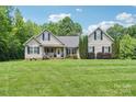 Inviting single-story home boasts a well-kept lawn and a charming covered front porch at 320 Bluegill Ln, Statesville, NC 28625