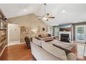 Bright living room features vaulted ceilings, a fireplace, and stylish contemporary furniture at 320 Bluegill Ln, Statesville, NC 28625