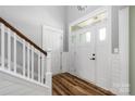 Bright foyer with hardwood floors and a staircase leading to the upper level at 3902 Mcgee Point Rd, Terrell, NC 28682