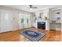 Inviting living room with hardwood floors, a decorative fireplace, and bright windows at 4007 Black Oak Rd, Hickory, NC 28602
