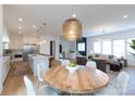 Bright open-concept living space featuring a dining area, kitchen, and cozy seating area at 4203 Walker Rd, Charlotte, NC 28211