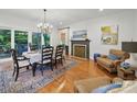 Dining room featuring hardwood floors, fireplace and backyard access through glass doors at 4644 Snow Dr, Harrisburg, NC 28075