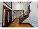 Elegant foyer features a grand staircase, hardwood floors, and a beautiful stained-glass door at 4672 Snow Dr, Harrisburg, NC 28075