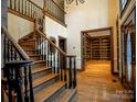 Spacious foyer boasts hardwood floors, elegant staircase, and an open view to the library at 4672 Snow Dr, Harrisburg, NC 28075