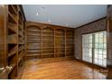 Cozy library featuring built-in bookshelves, hardwood floors, and natural light at 4672 Snow Dr, Harrisburg, NC 28075